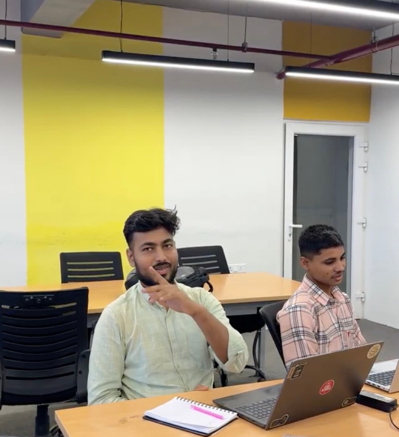 A member pointing towards the camera, mid-reply
